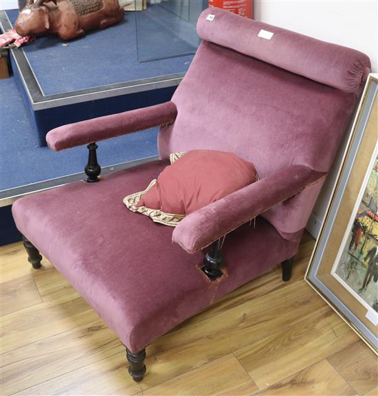 A late 19th century upholstered ebonised club armchair